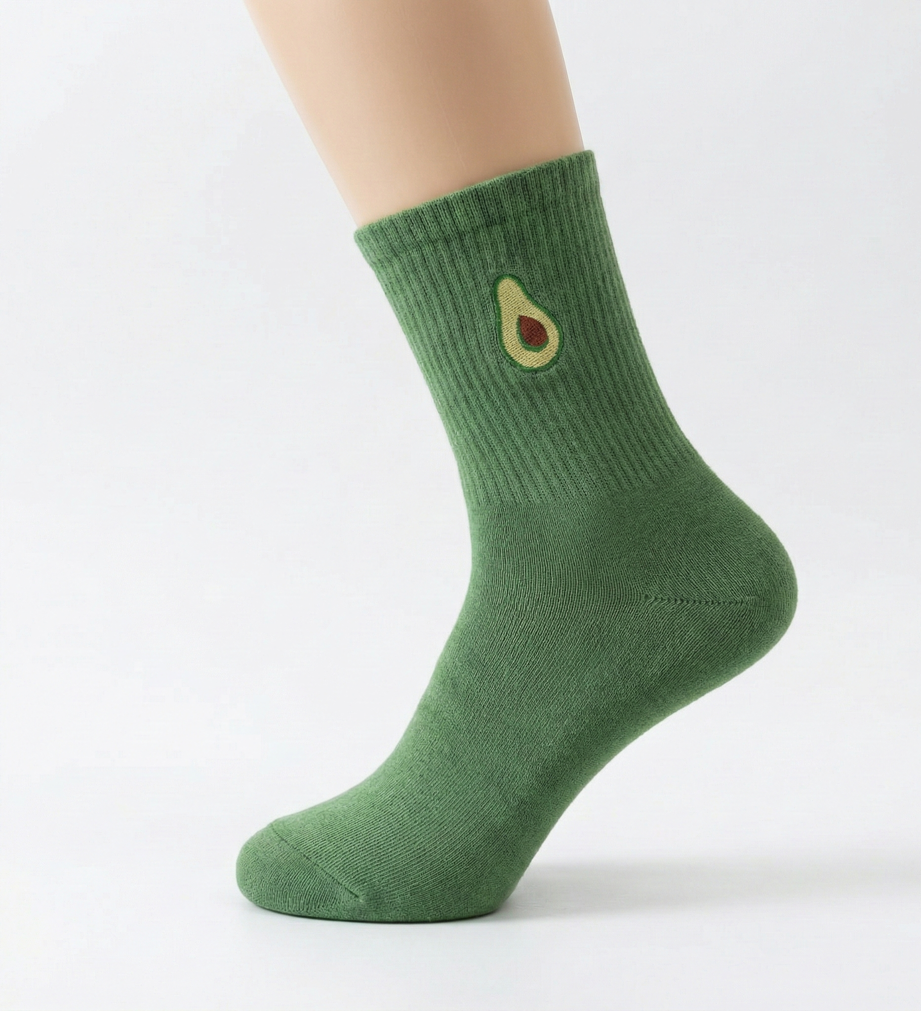 Green sock with avocado design on a white background