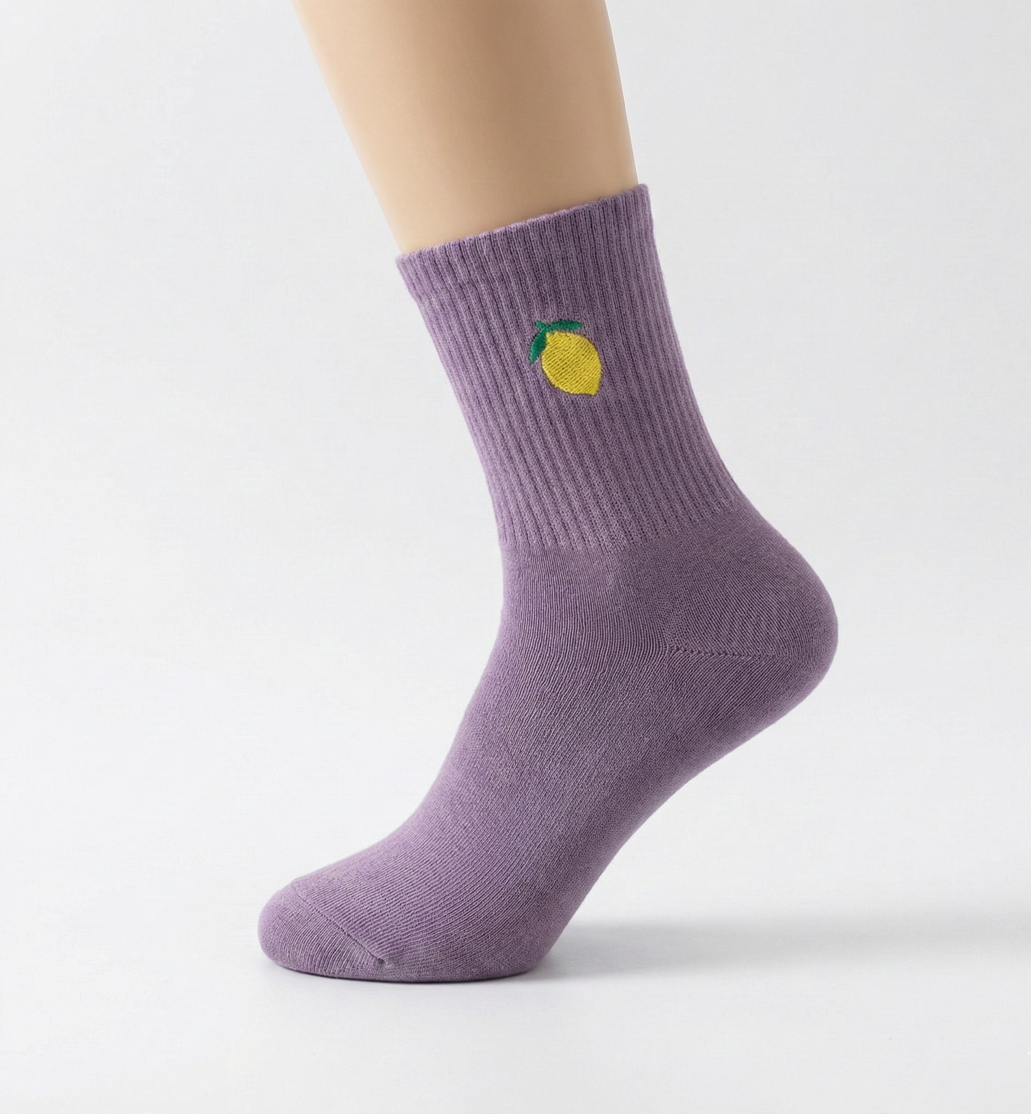 Purple sock with a lemon design on a white background