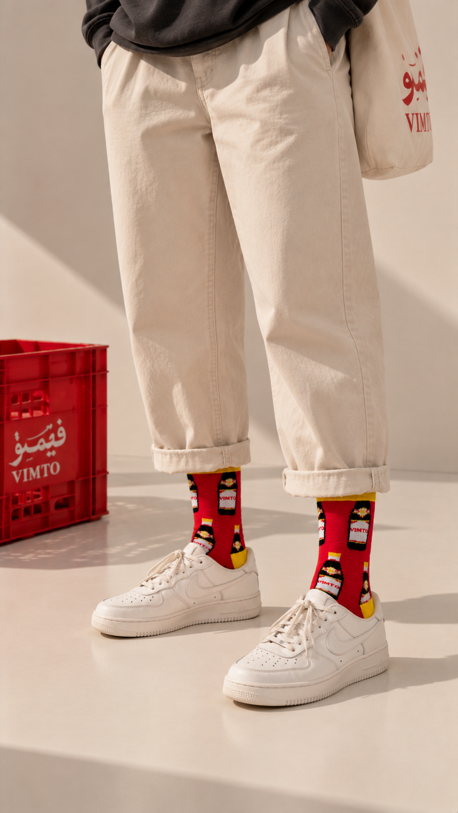 Vimto half crew socks by Socks Up, worn with cream trousers and white sneakers