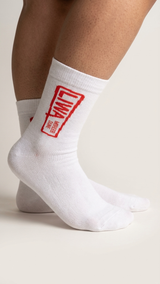 Liwa half crew socks by Socks Up, worn on feet, white with the red LIWA Moreeb Dune stamp