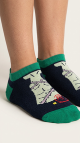 Demon Slayer ankle socks with green cuff, navy base, and cream character.