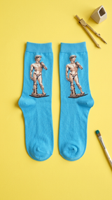 Pair of bright blue socks with Michelangelo's David statue design printed.